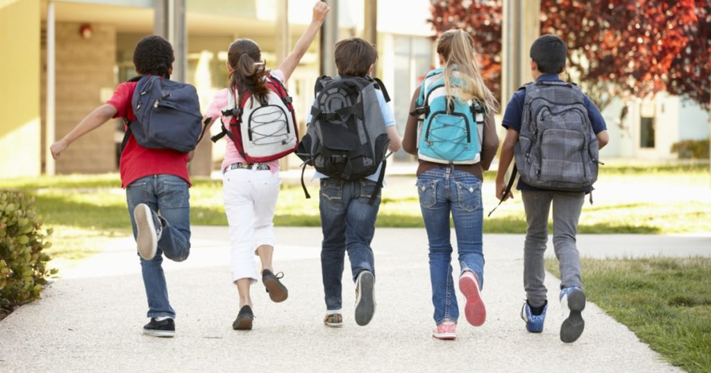 children wearing backpacks